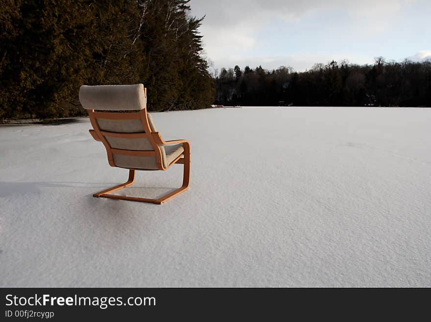 A luxury chair stands on a frozen lake. A luxury chair stands on a frozen lake