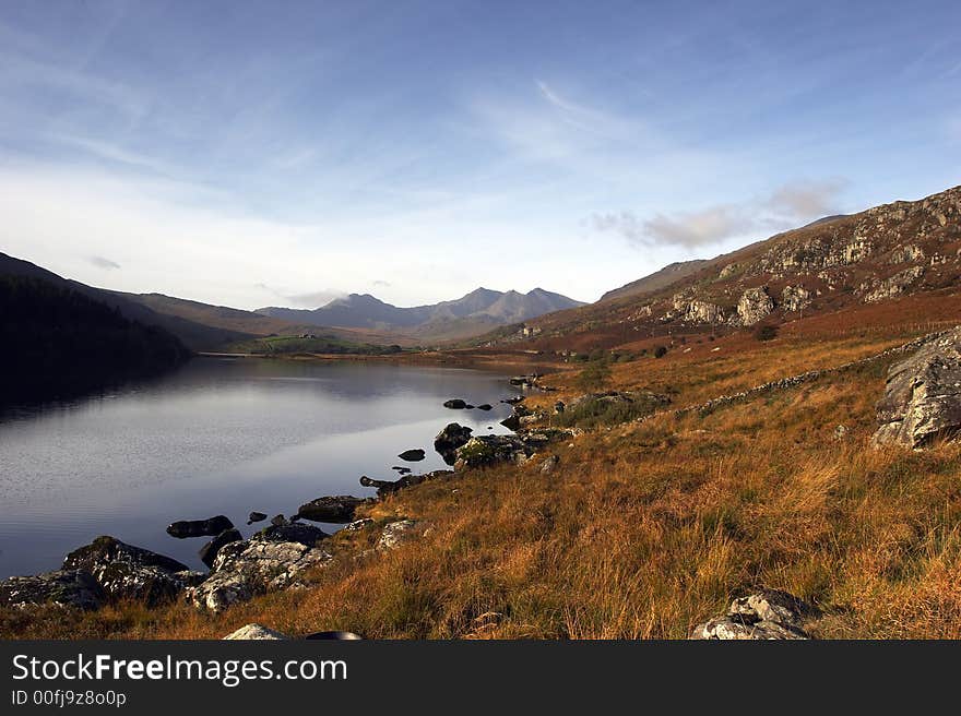 Autumn at Llynnau Mymbyr, Capel Curig, Wales, UK. The Snowdon Horseshoe mountain range dominates the background.