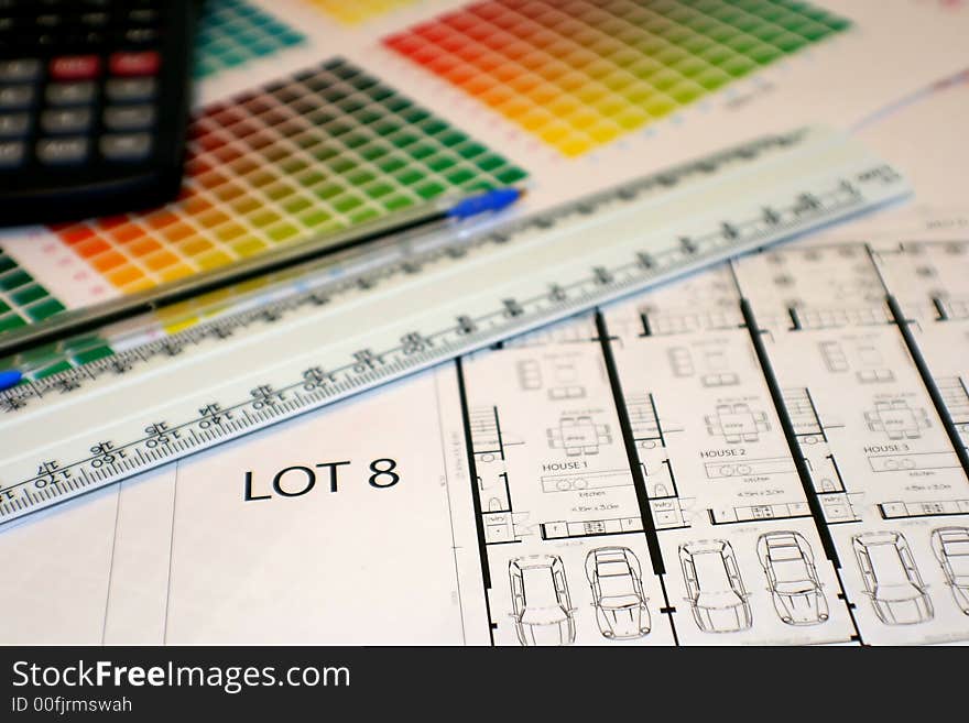 Colour chart, ruler, pen, calculator and plans... on a desk ready to be studied!. Colour chart, ruler, pen, calculator and plans... on a desk ready to be studied!