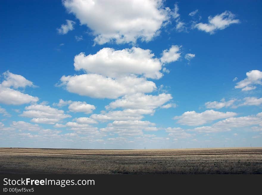 Sky above the field and clouds