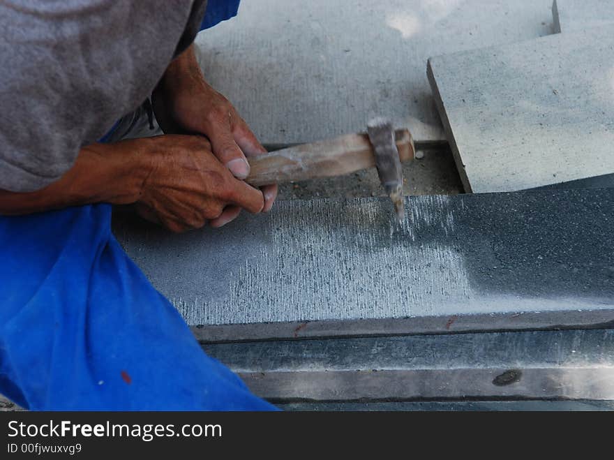 Man working on the stone with hammer. Man working on the stone with hammer