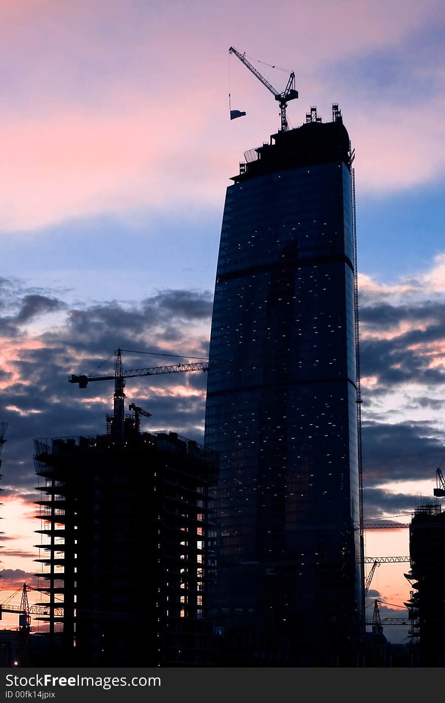 Building site in the developing business center in the evening. Building site in the developing business center in the evening