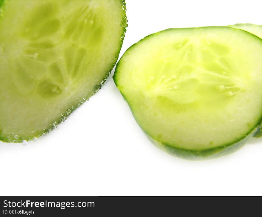 Slices of a cucumber, separately, on a white background. Slices of a cucumber, separately, on a white background.