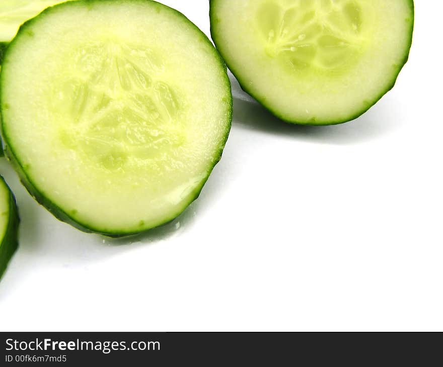 Slices of a cucumber, separately, on a white background. Slices of a cucumber, separately, on a white background.