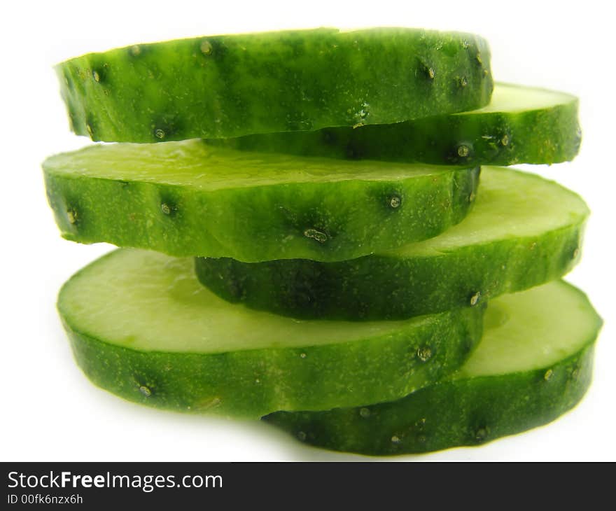 Slices of a cucumber, separately, on a white background. Slices of a cucumber, separately, on a white background.