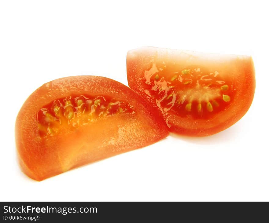 Slices of a tomato, separately, on a white background. Slices of a tomato, separately, on a white background.