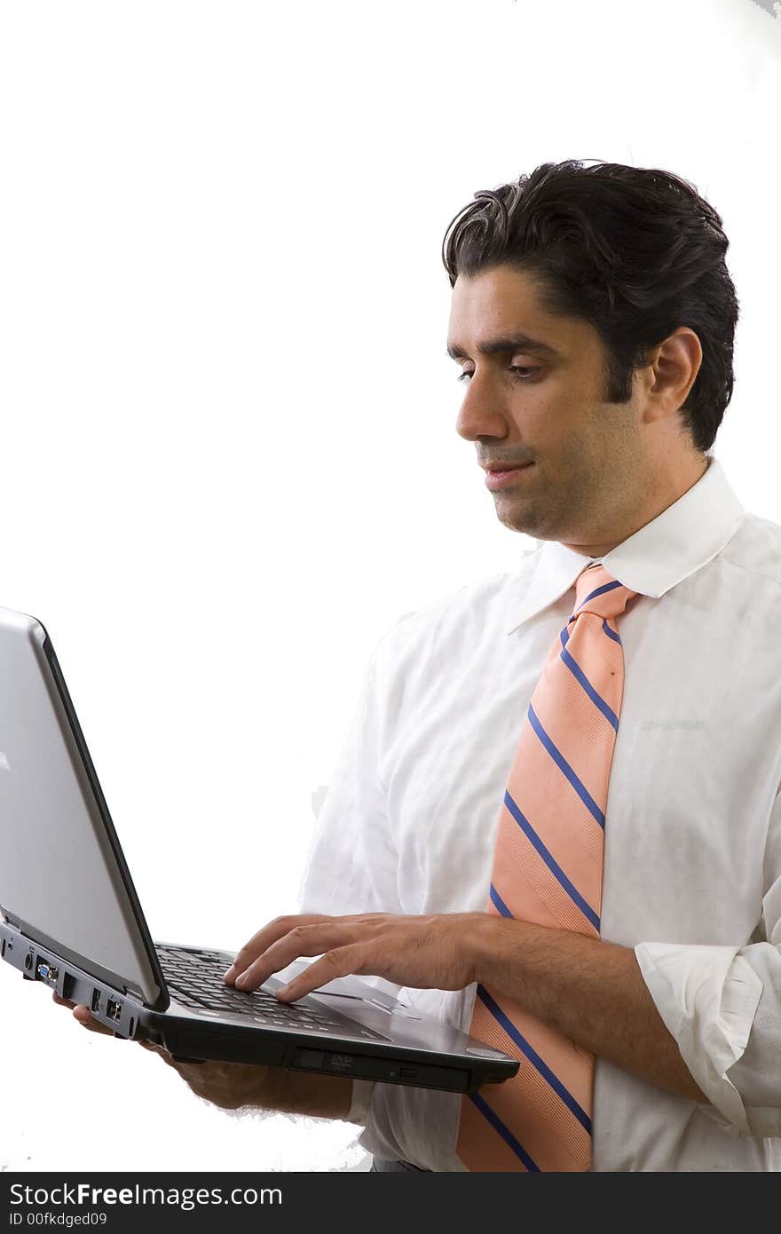 Young, vital businessman working on a laptop computer. Young, vital businessman working on a laptop computer.