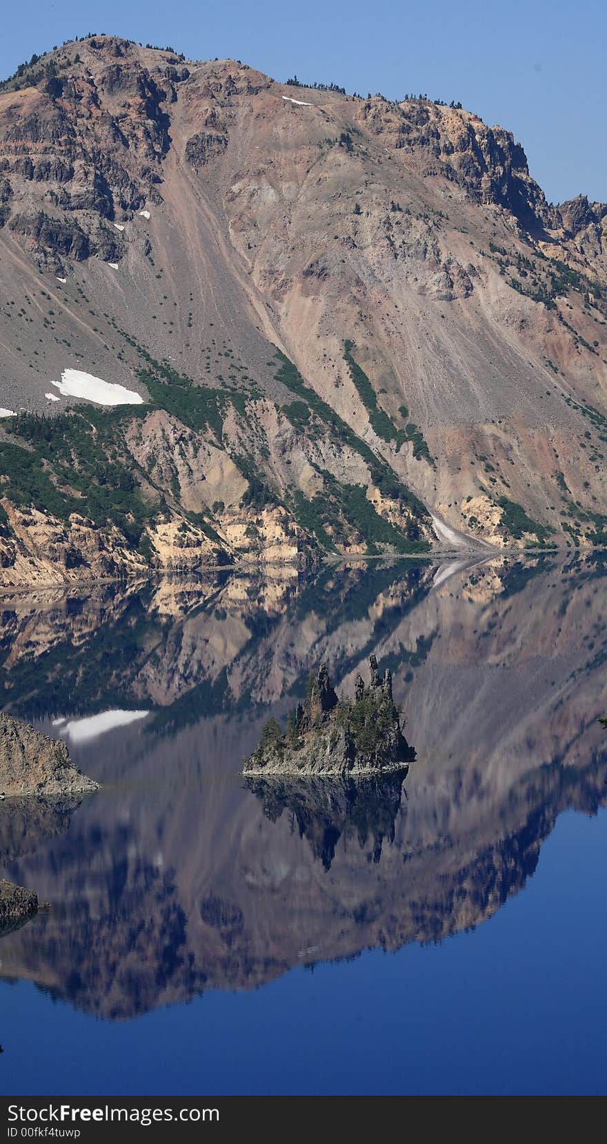 Phantom ship. Reflection of the island and mountain in the water