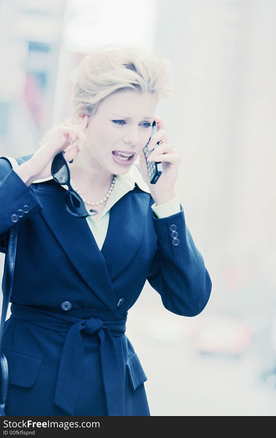 Female executive on cell phone on downtown street. Female executive on cell phone on downtown street