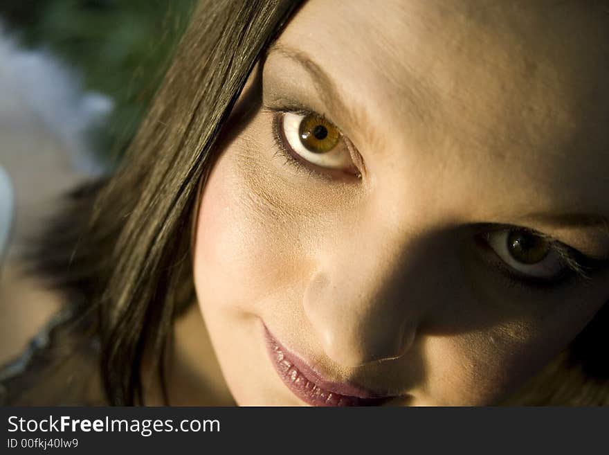 Beautiful brunette evil fairy looking up at the camera with brown eyes (wing to the left). Beautiful brunette evil fairy looking up at the camera with brown eyes (wing to the left)