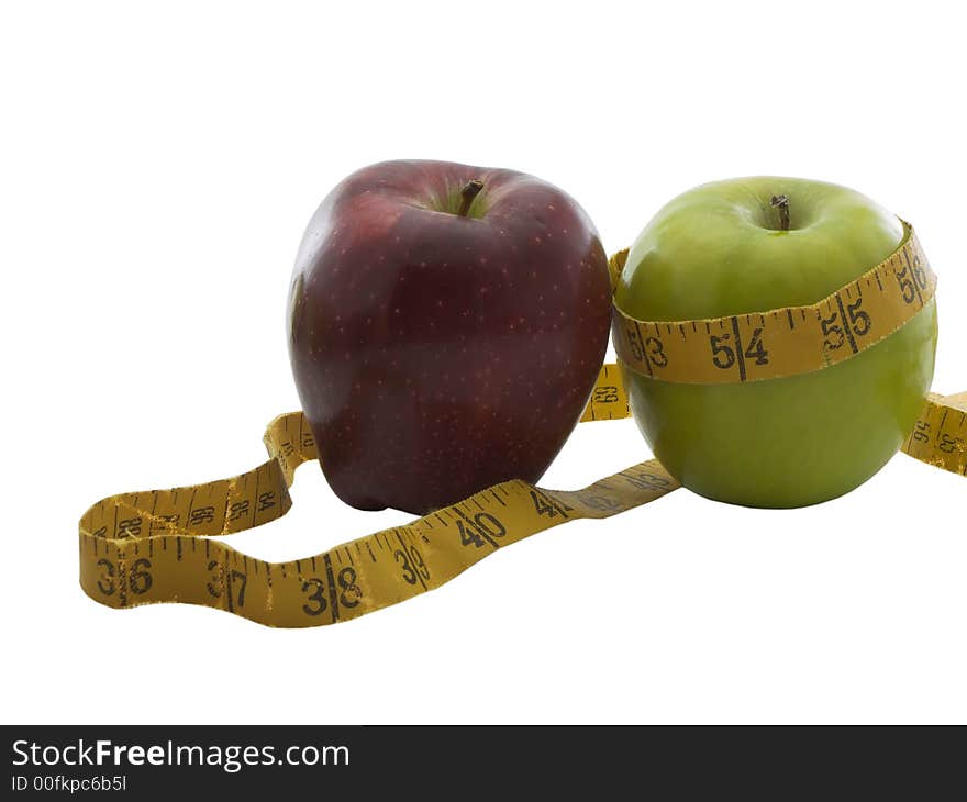 Photo of a green and red apple with a measuring tape around them, isolated on white. Photo of a green and red apple with a measuring tape around them, isolated on white