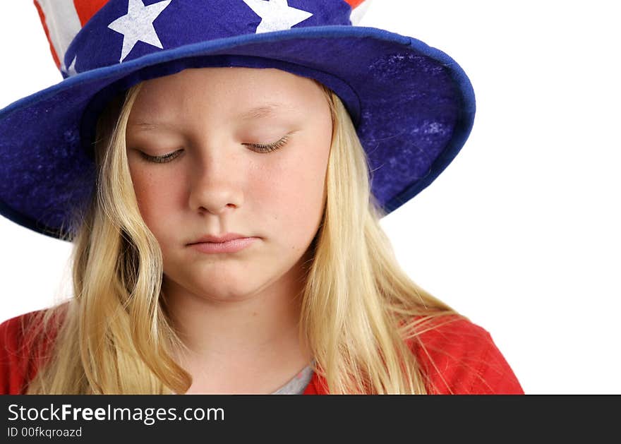 A beautiful young girl wearing a patriotic American hat and looking sad. A beautiful young girl wearing a patriotic American hat and looking sad.