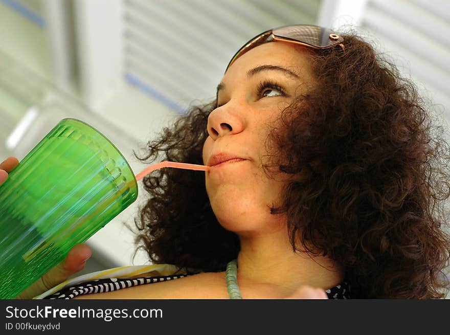 Low angle shot of a culry-haired lemonade destroyer. Low angle shot of a culry-haired lemonade destroyer