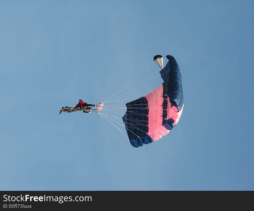 The parachuter on a background of the blue sky