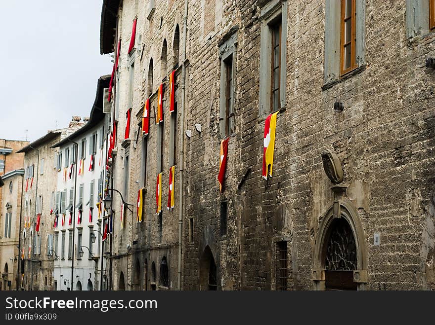 Old facade with the flags of the group at the window, Gubbio