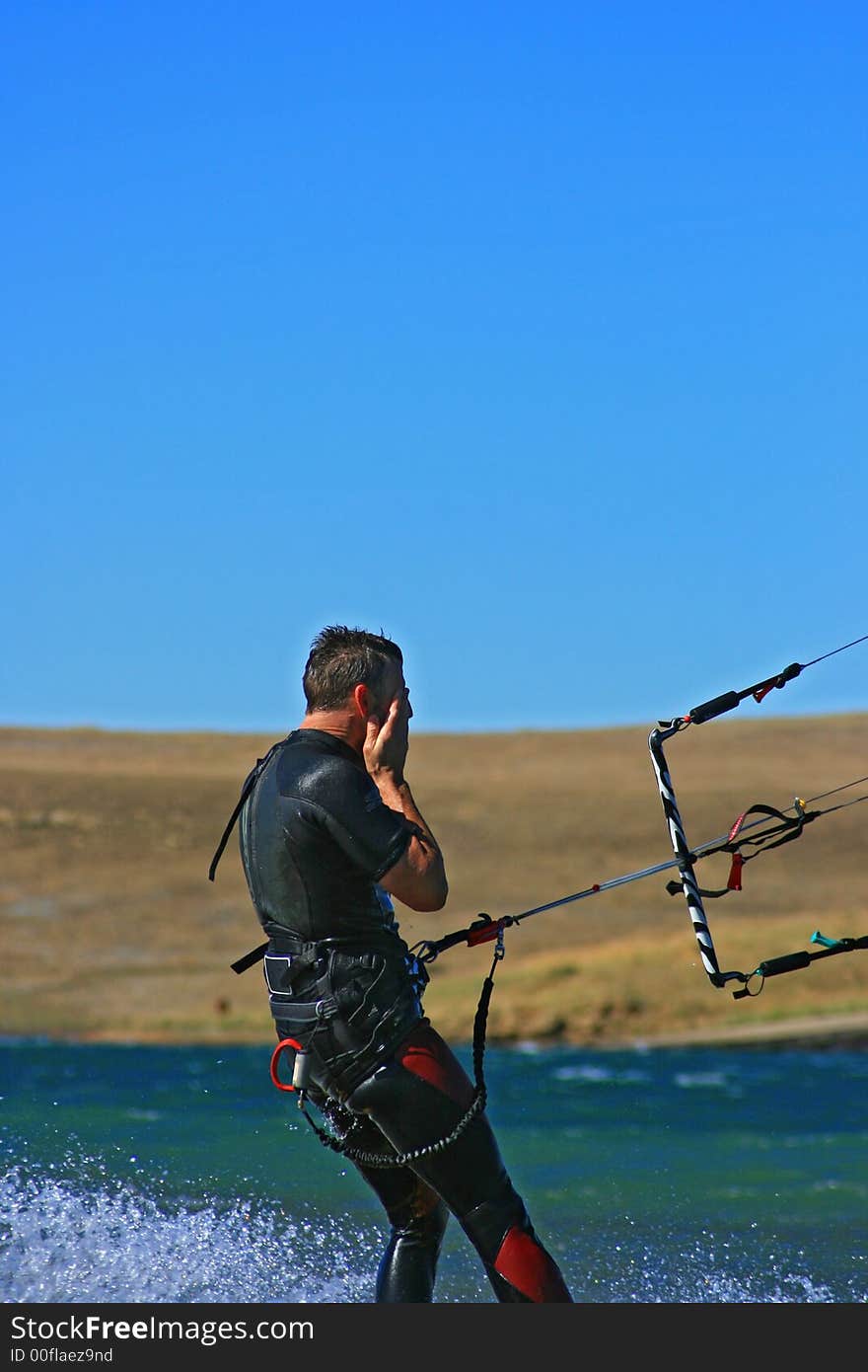 A kiter inland, kitesurfing without hands on bar, but instead on his eyes. A kiter inland, kitesurfing without hands on bar, but instead on his eyes