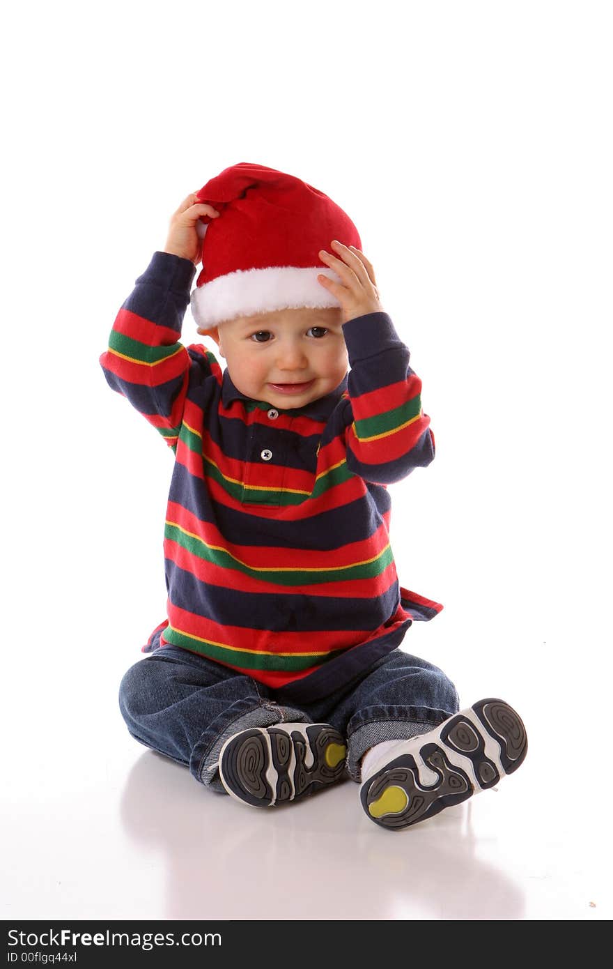 Baby holding his santa hat. Baby holding his santa hat