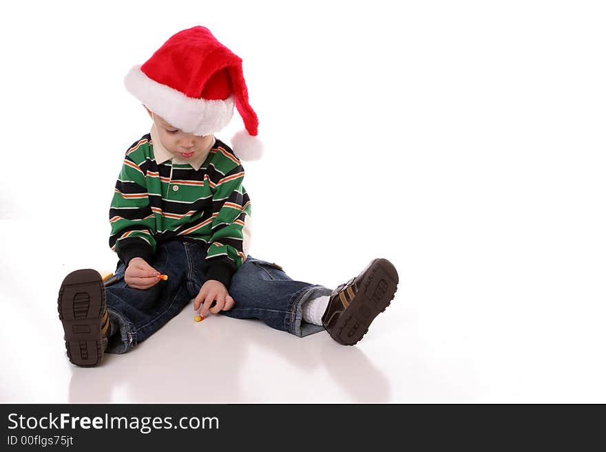 Little boy looking down in santa hat. Little boy looking down in santa hat