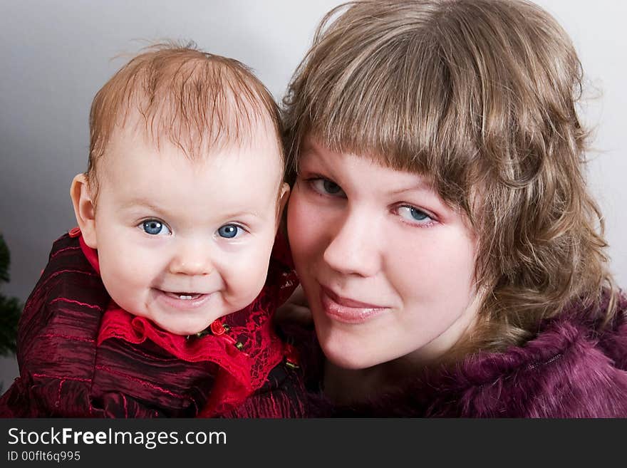 Loving mother with her little cute daughter looking into camera. Loving mother with her little cute daughter looking into camera