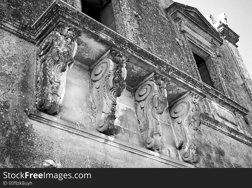 An ancient balcony with he-goats n the old abandoned house