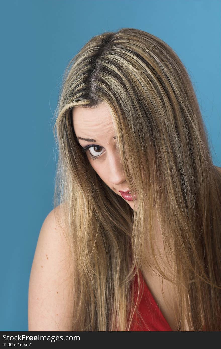 Studio portrait shot of  beautiful youg girl over blue drop