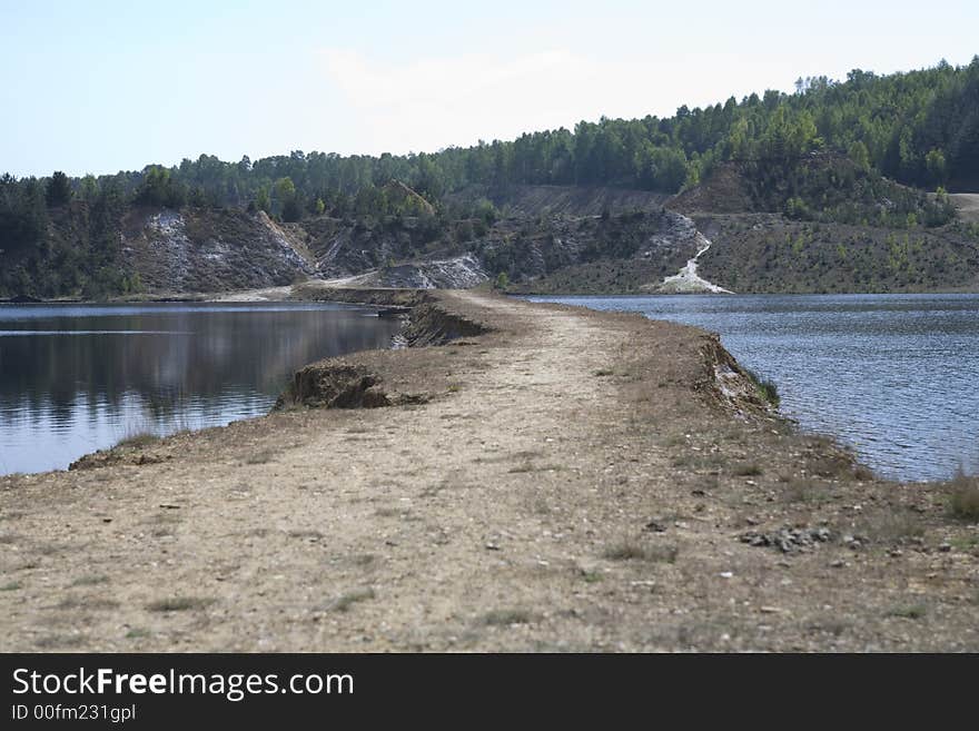 A small road seprating two lakes in two. A small road seprating two lakes in two