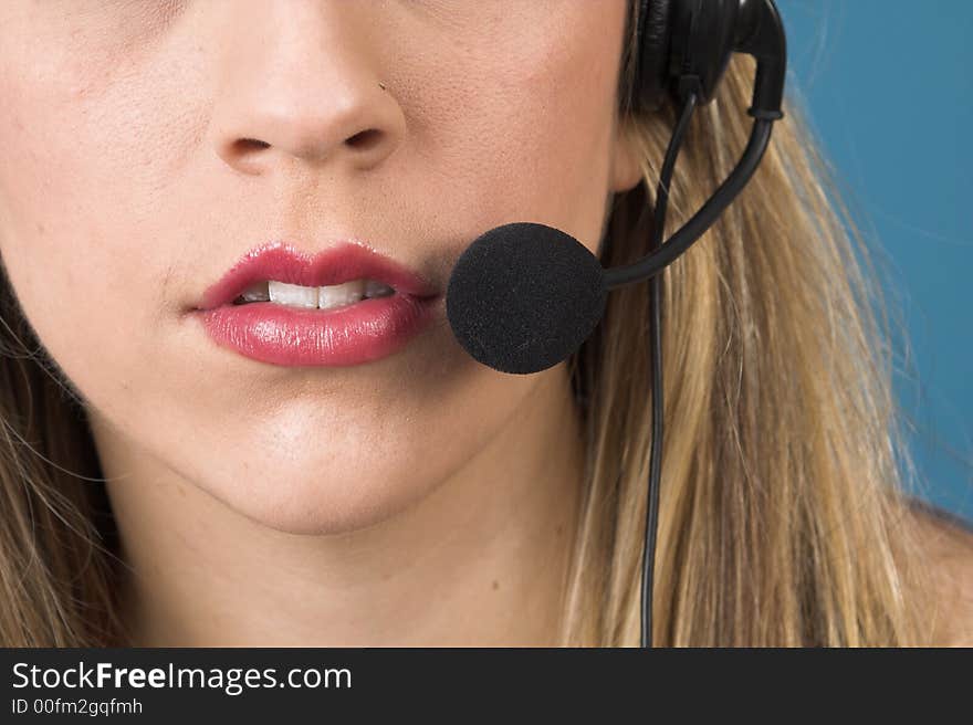 Macro of receptionist with headset over blue drop