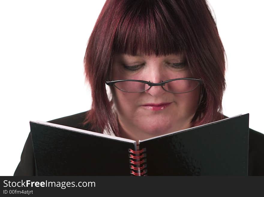 Business woman, looking down, reading notebook. Business woman, looking down, reading notebook