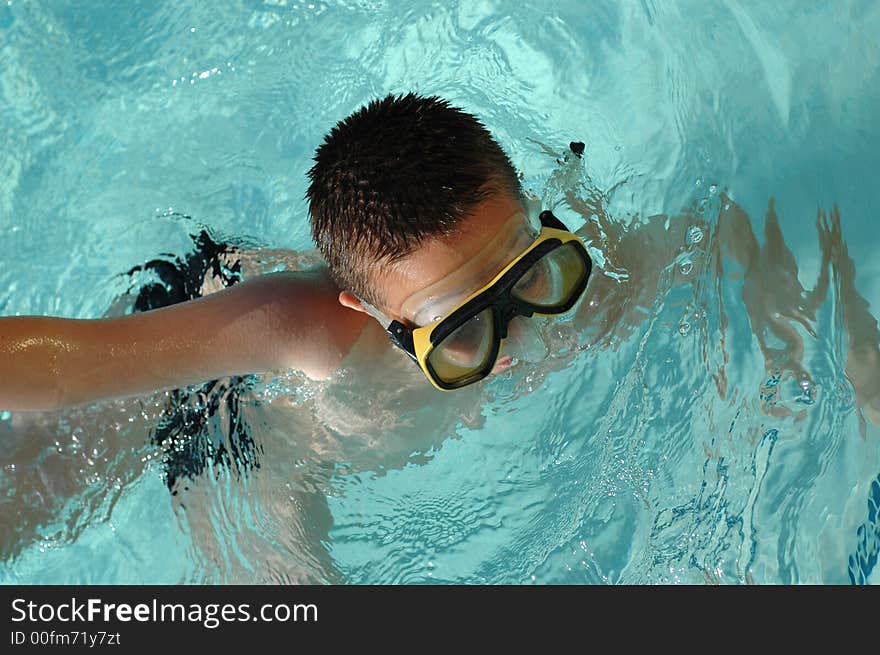 Nine year old boy swimming a freestyle dash. Nine year old boy swimming a freestyle dash