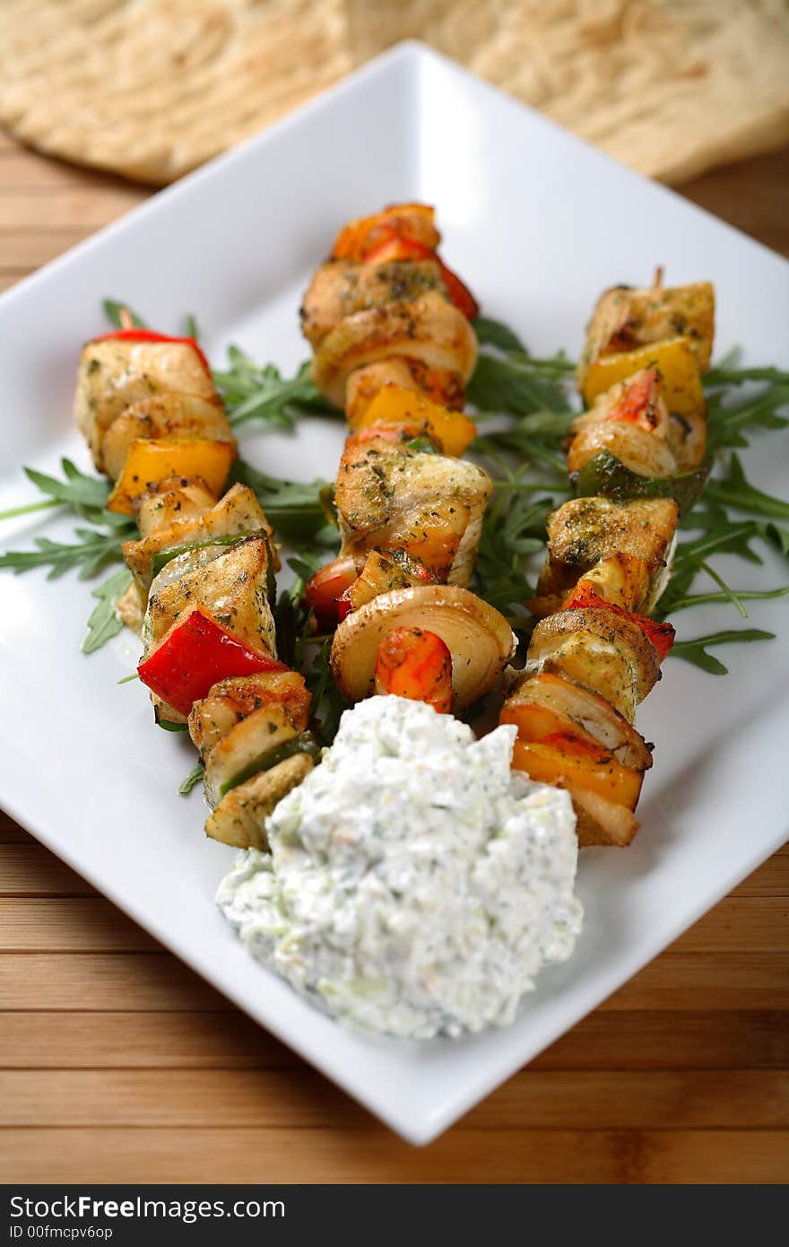 Three shashliks with garlic spread on the plate