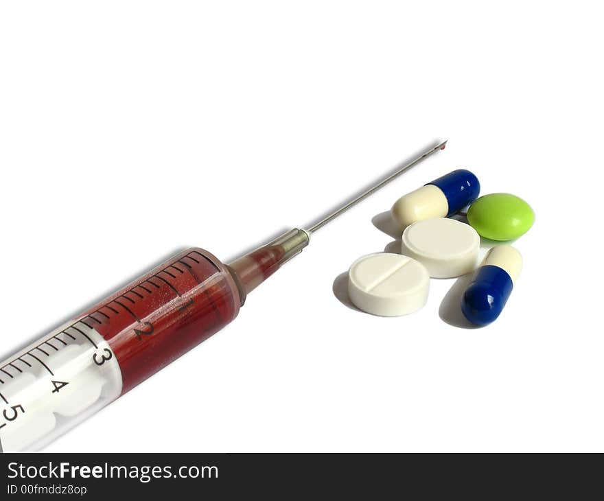 Medicines and a syringe on a white background