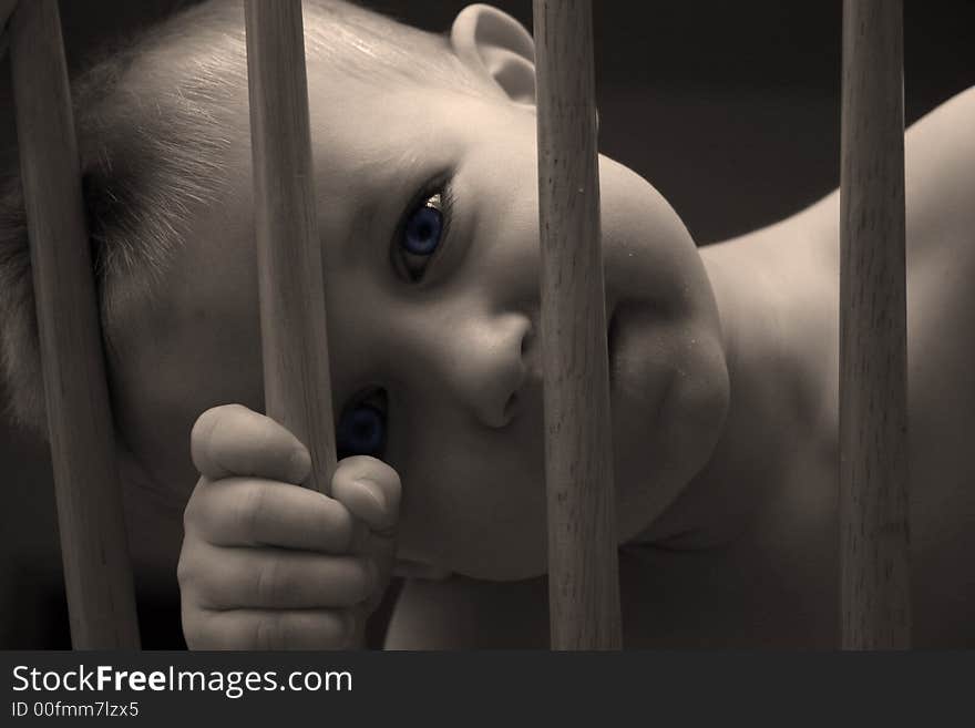 A toddler boy looking through the back of a chair. A toddler boy looking through the back of a chair.