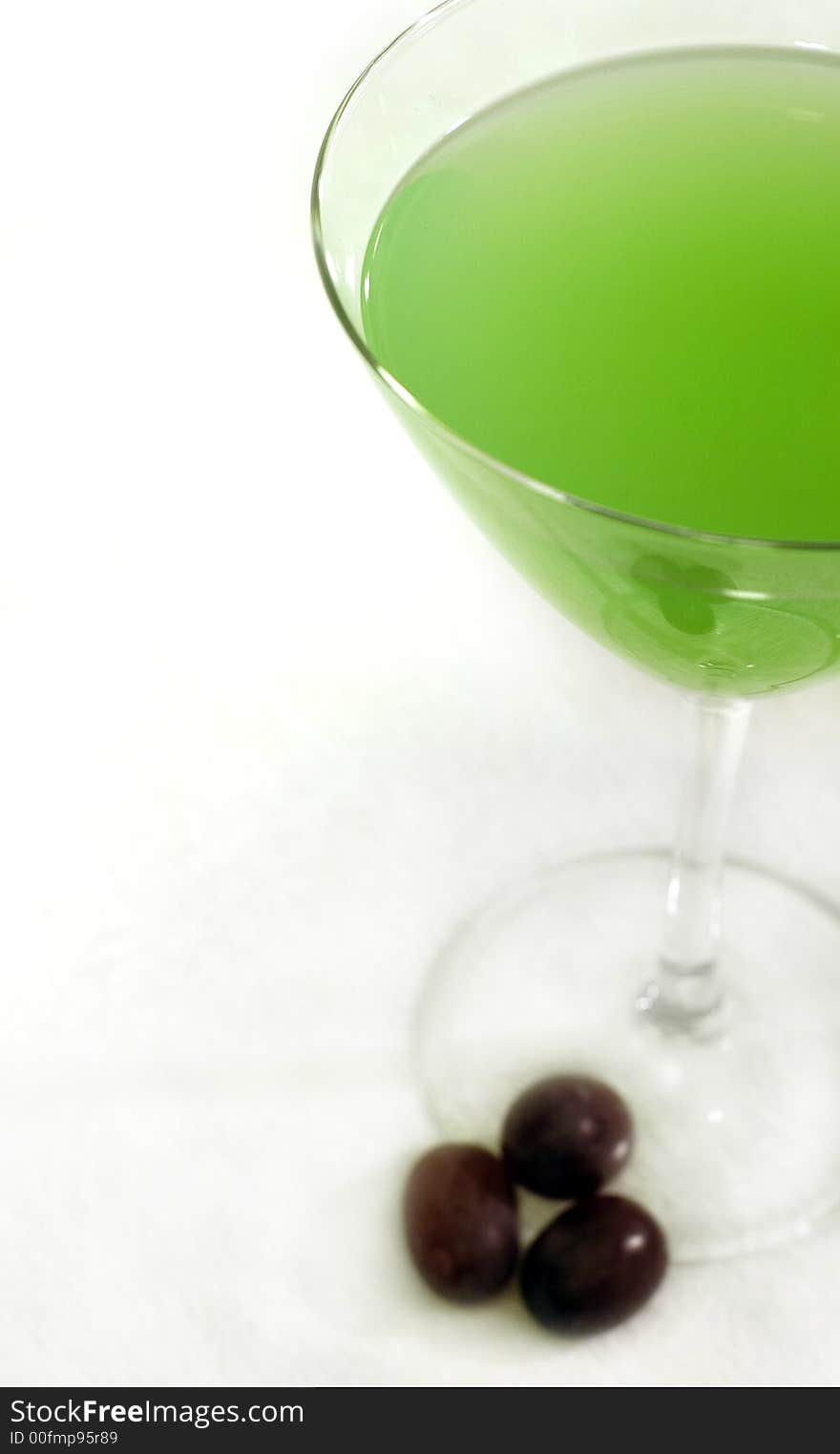 A summery green cocktail with some grapes on a white background. A summery green cocktail with some grapes on a white background.