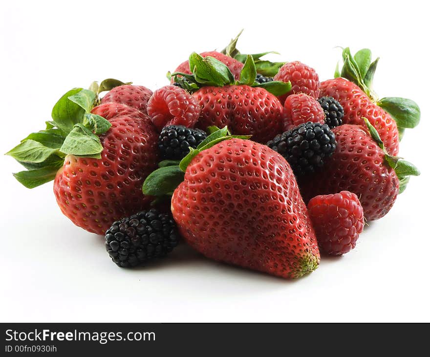 Strawberries, raspberries, and blackberries on white