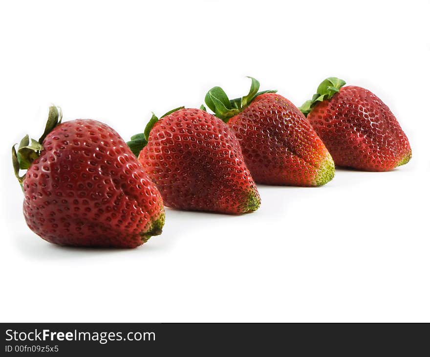 Four strawberries shot on a white background