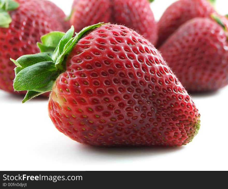 Close-up of a strawberry with other strawberries in the background