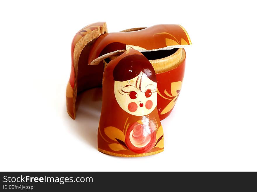 Pieces of broken nesting doll lying on a white background