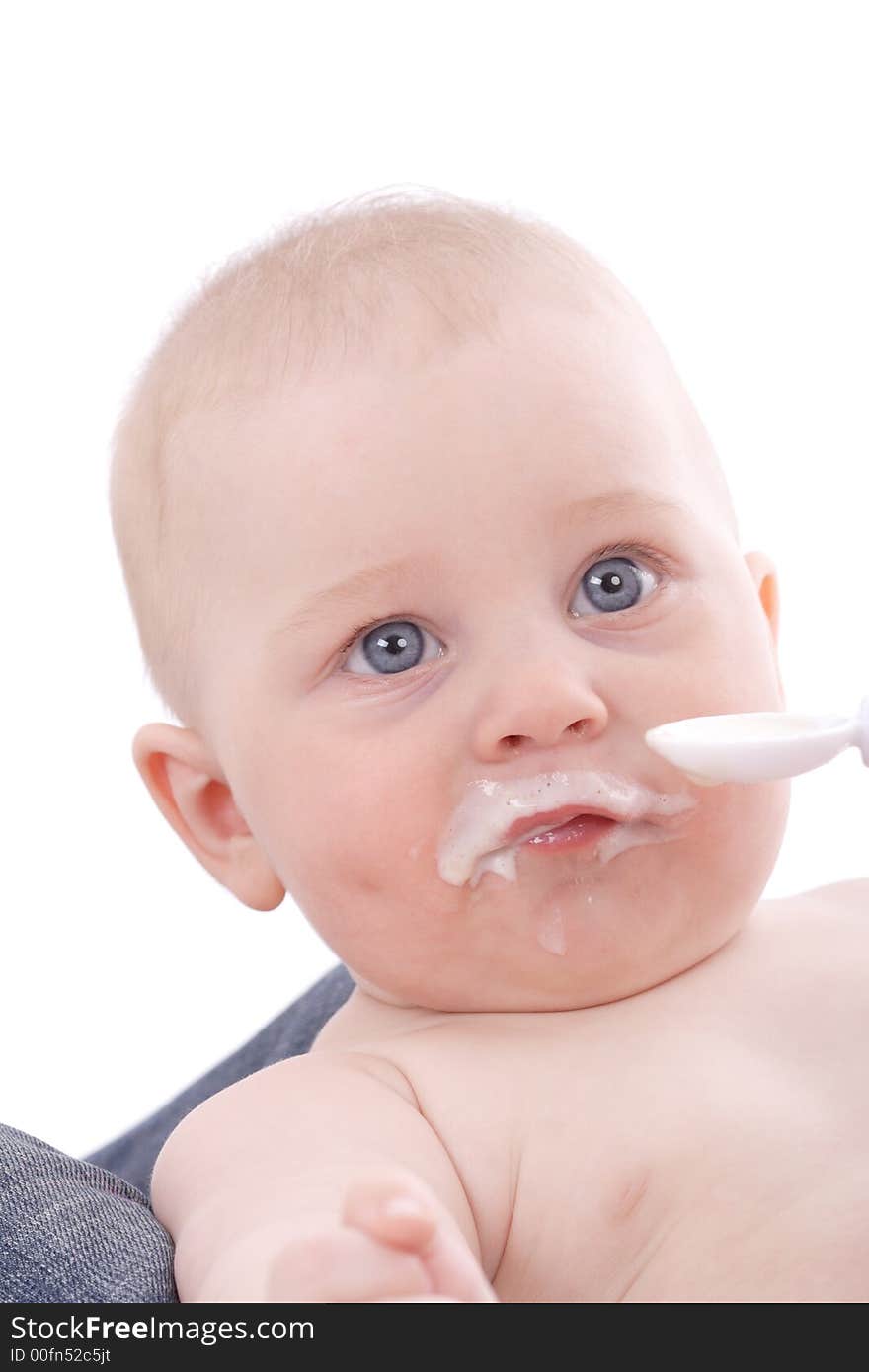 Feeding. Beautiful baby. Shot in studio. Isolated on white. Feeding. Beautiful baby. Shot in studio. Isolated on white.