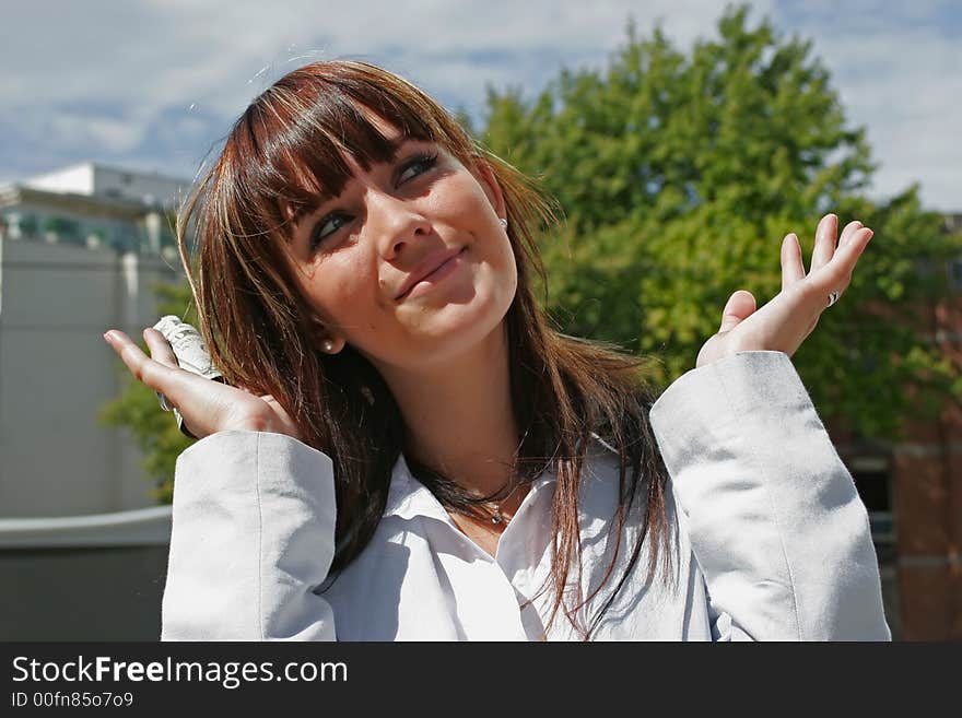 A portrait of a girl smiling downtown with dollars in a hand. A portrait of a girl smiling downtown with dollars in a hand