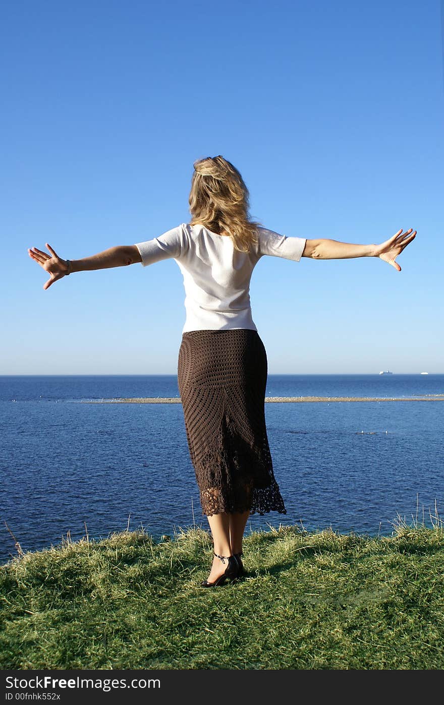 Beautiful girl jumping in to the deep blue sea. Beautiful girl jumping in to the deep blue sea