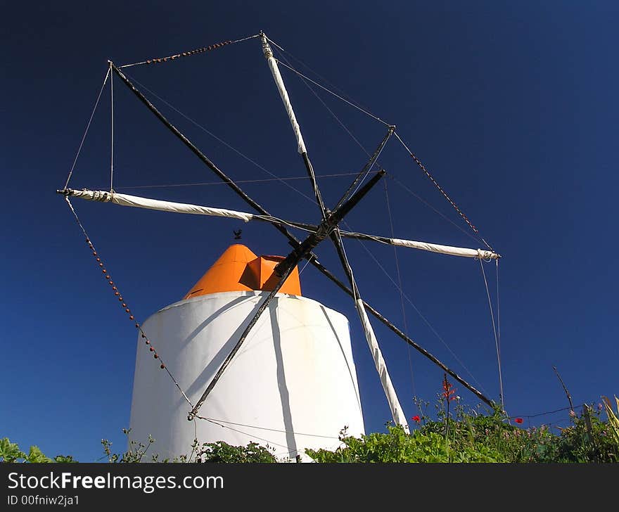 Ancient windmill in Portugal, canvas rolled up.