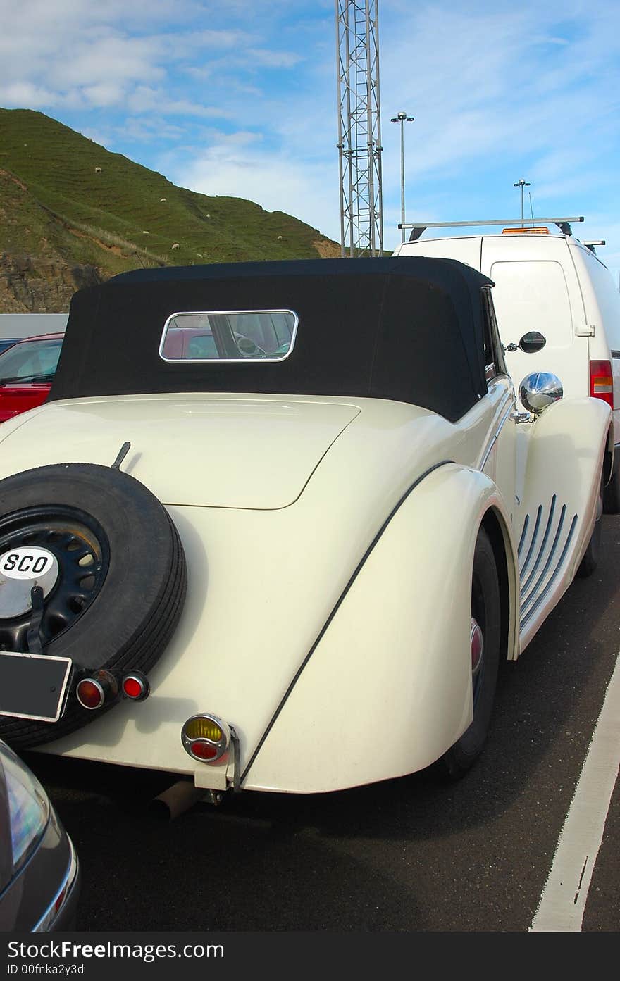 A  classic car waiting in line to be loaded onto a ferry. A  classic car waiting in line to be loaded onto a ferry.