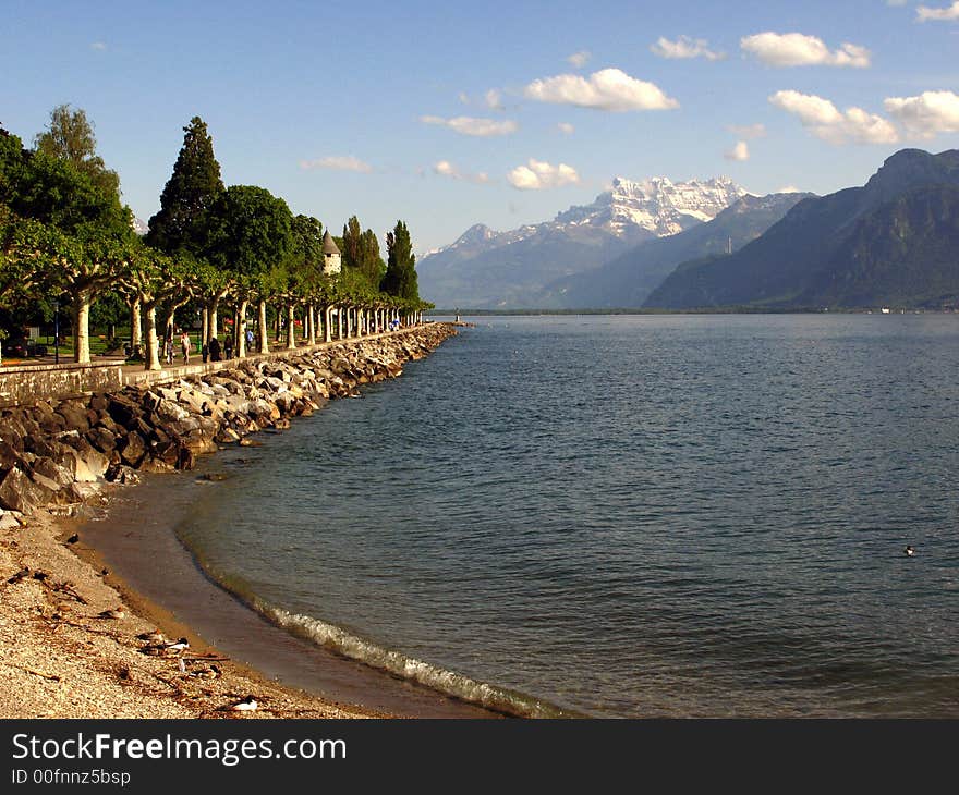 A small beach on the Lake Geneva (Leman) in Vevey with a view towards the Dents du Midi, a spectacular mountain range in the Swiss Alps. A small beach on the Lake Geneva (Leman) in Vevey with a view towards the Dents du Midi, a spectacular mountain range in the Swiss Alps.