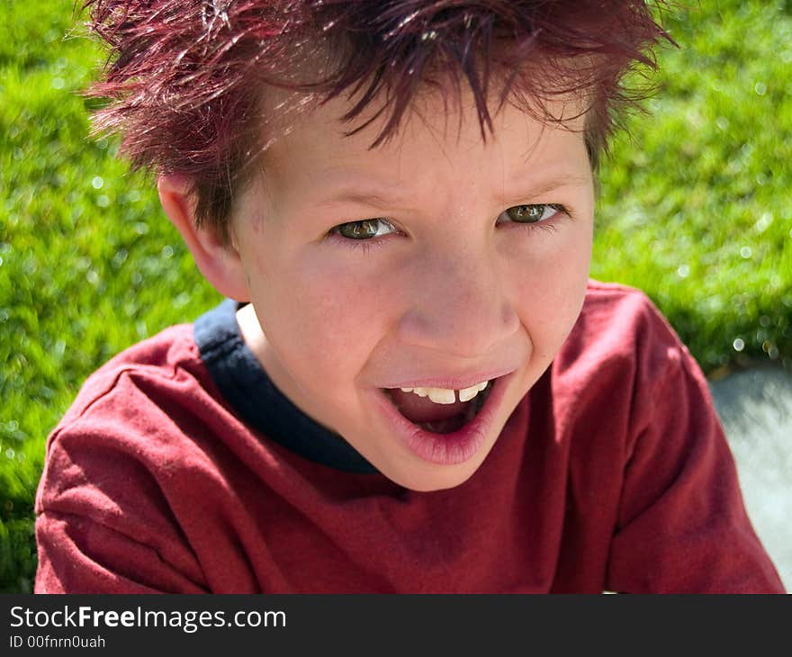 Little boy with crazy hair yells to the camera