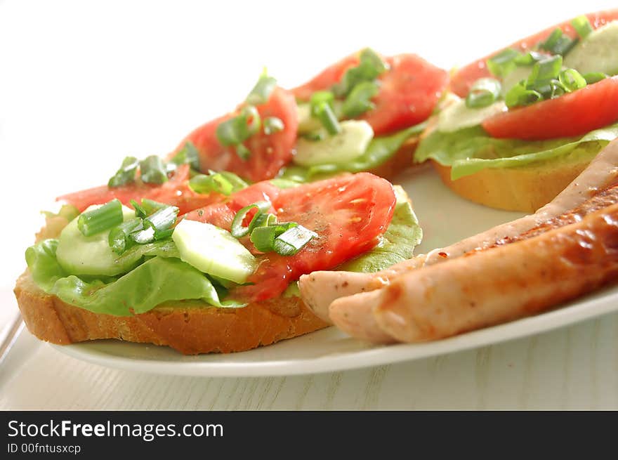 Plate with sandwiches and sausages