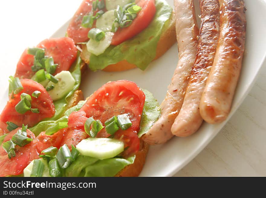 Plate with sandwiches and sausages