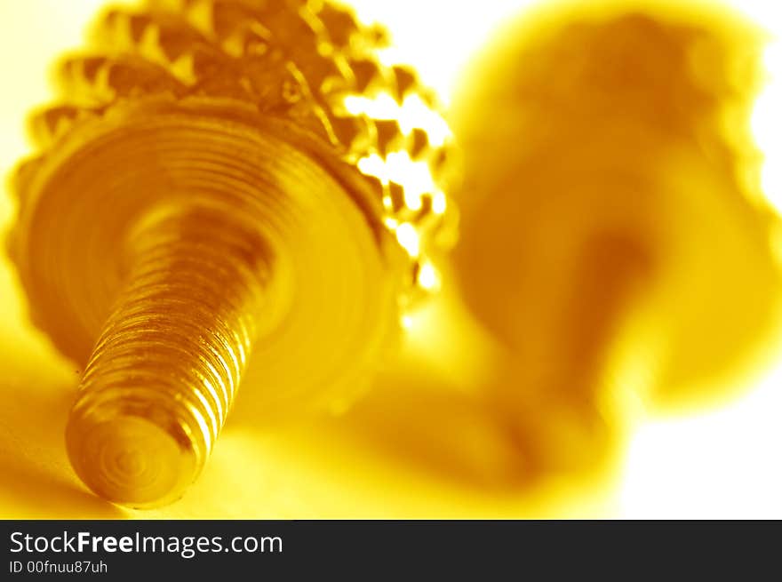 Yellow screw close-up. Conceptual image