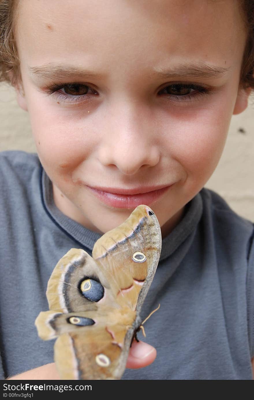 Boy holding Poly Anheria moth