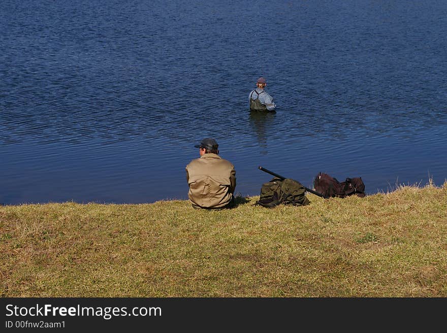 Two fishermen on lake in the early spring. Two fishermen on lake in the early spring