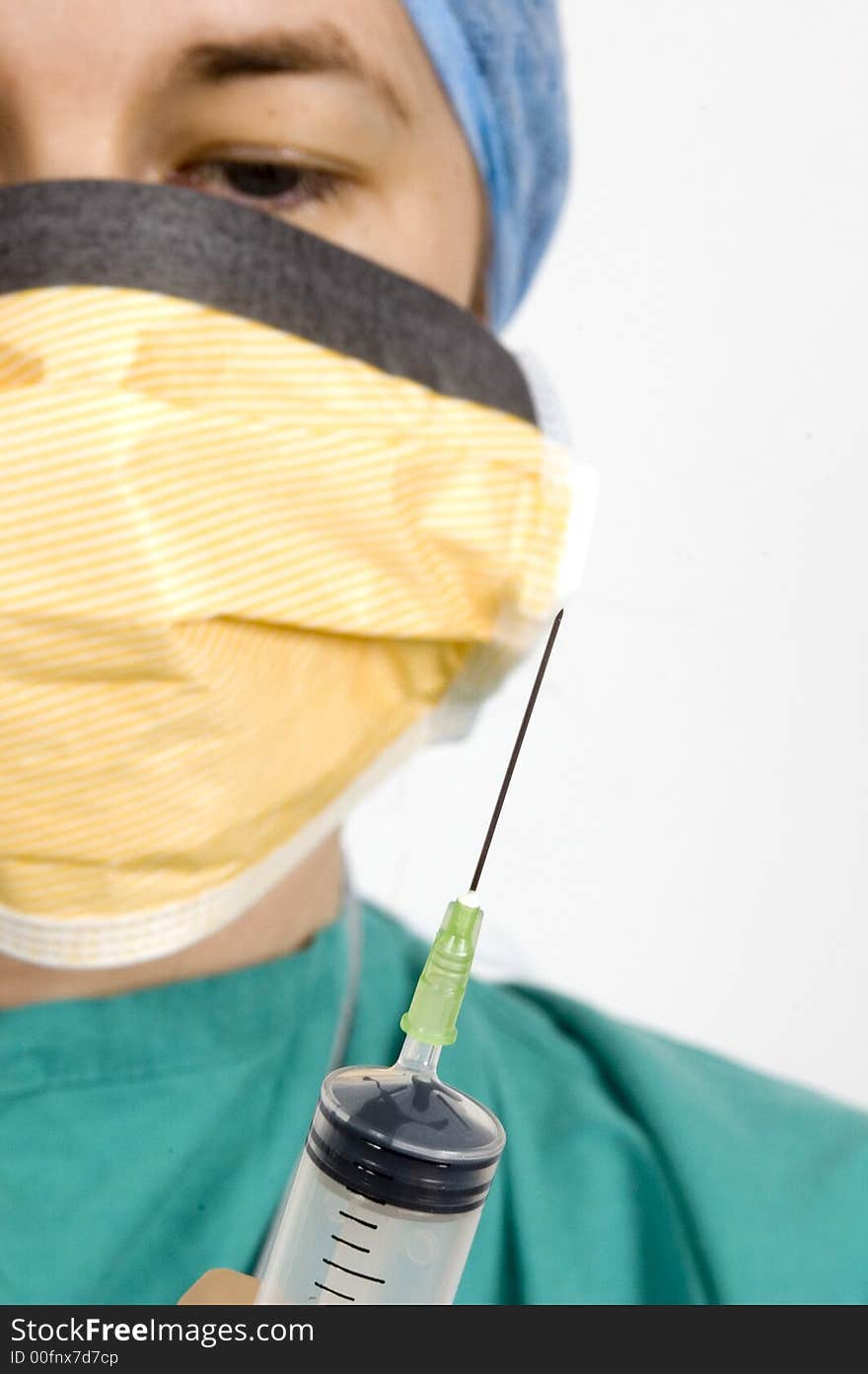 A shot of a syringe being held by a female medical practitioner. A shot of a syringe being held by a female medical practitioner